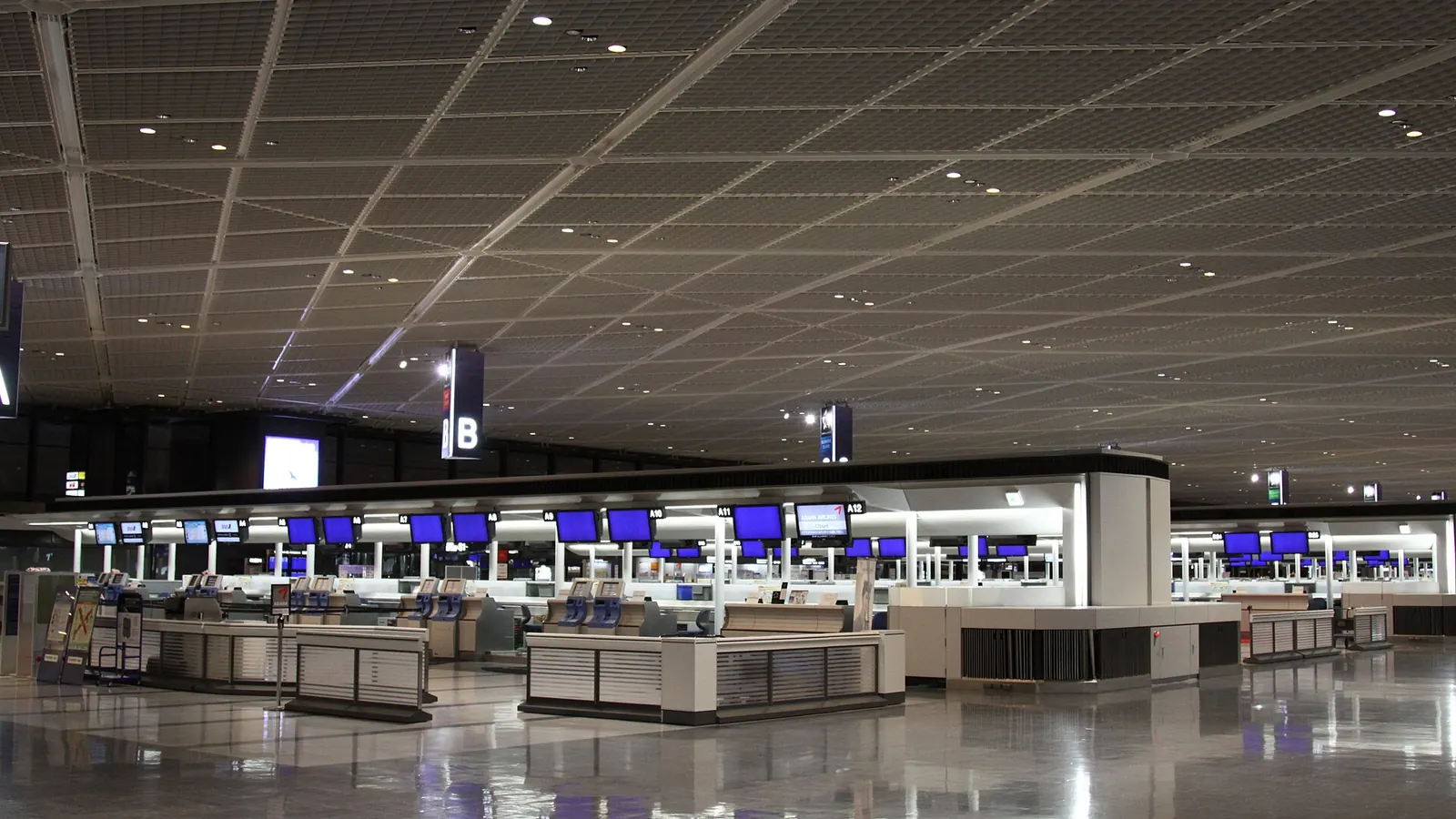 成田空港第 1 ターミナルの出発ロビー。チェックインカウンターが並ぶ
